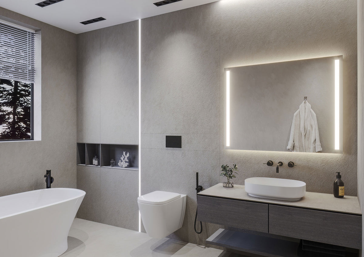 Baño con bañera exenta y espejo rectangular HERA encendido, con luz frontal lateral y luz ambiental arriba y abajo