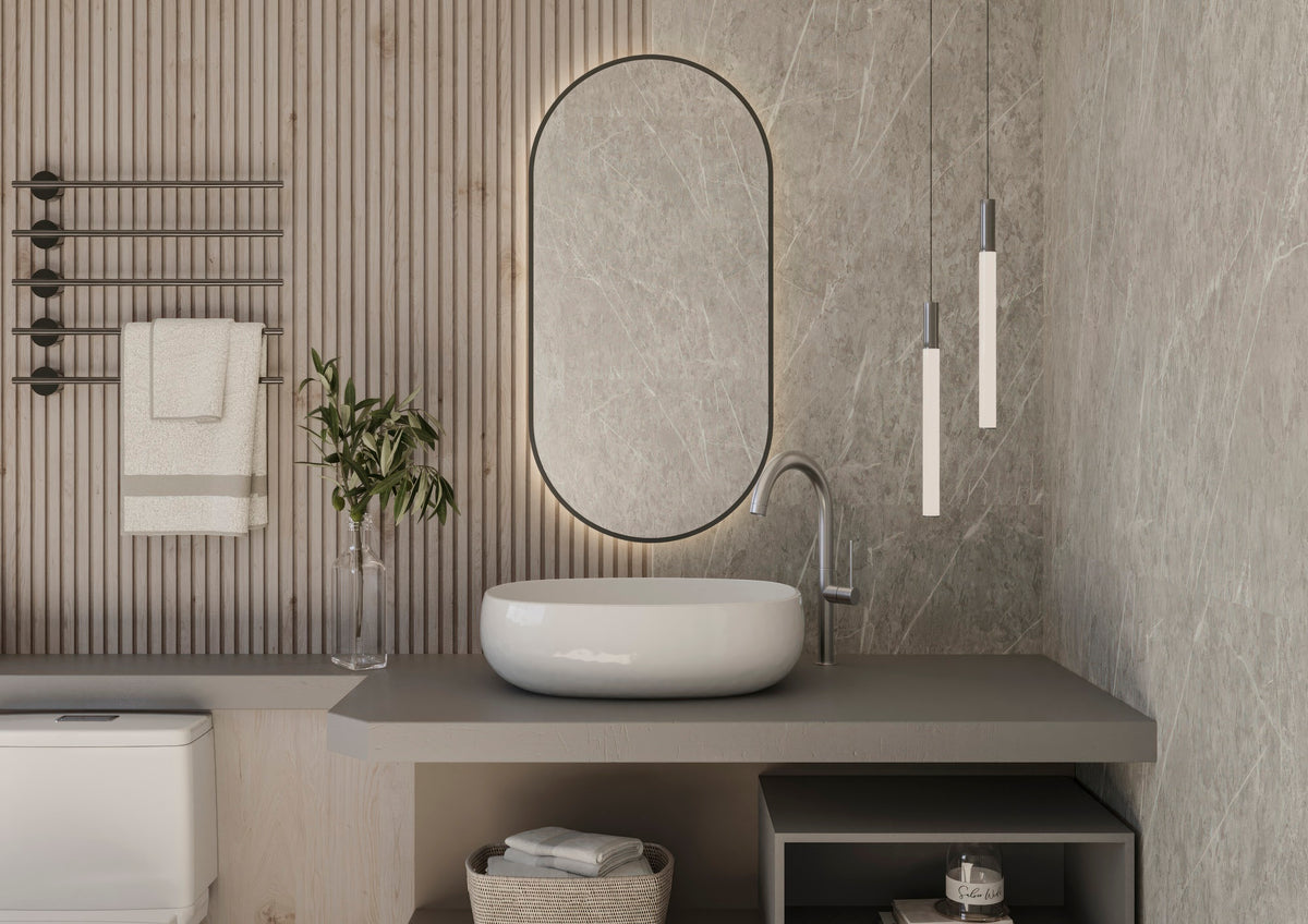 Espejo de baño JAPÓN en forma de cápsula, retroiluminado y con el borde pintado en negro, sobre un lavabo de piedra